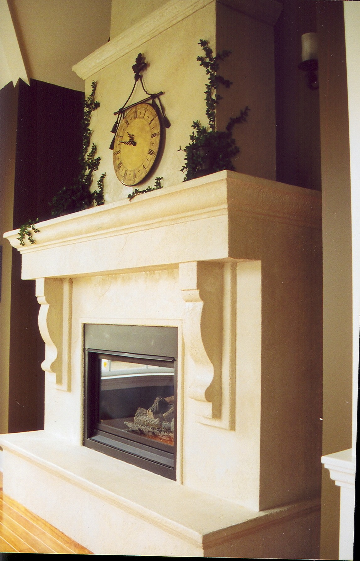 Traditional mantel-to-floor StoneCraft fireplace with decorative clock and ivy