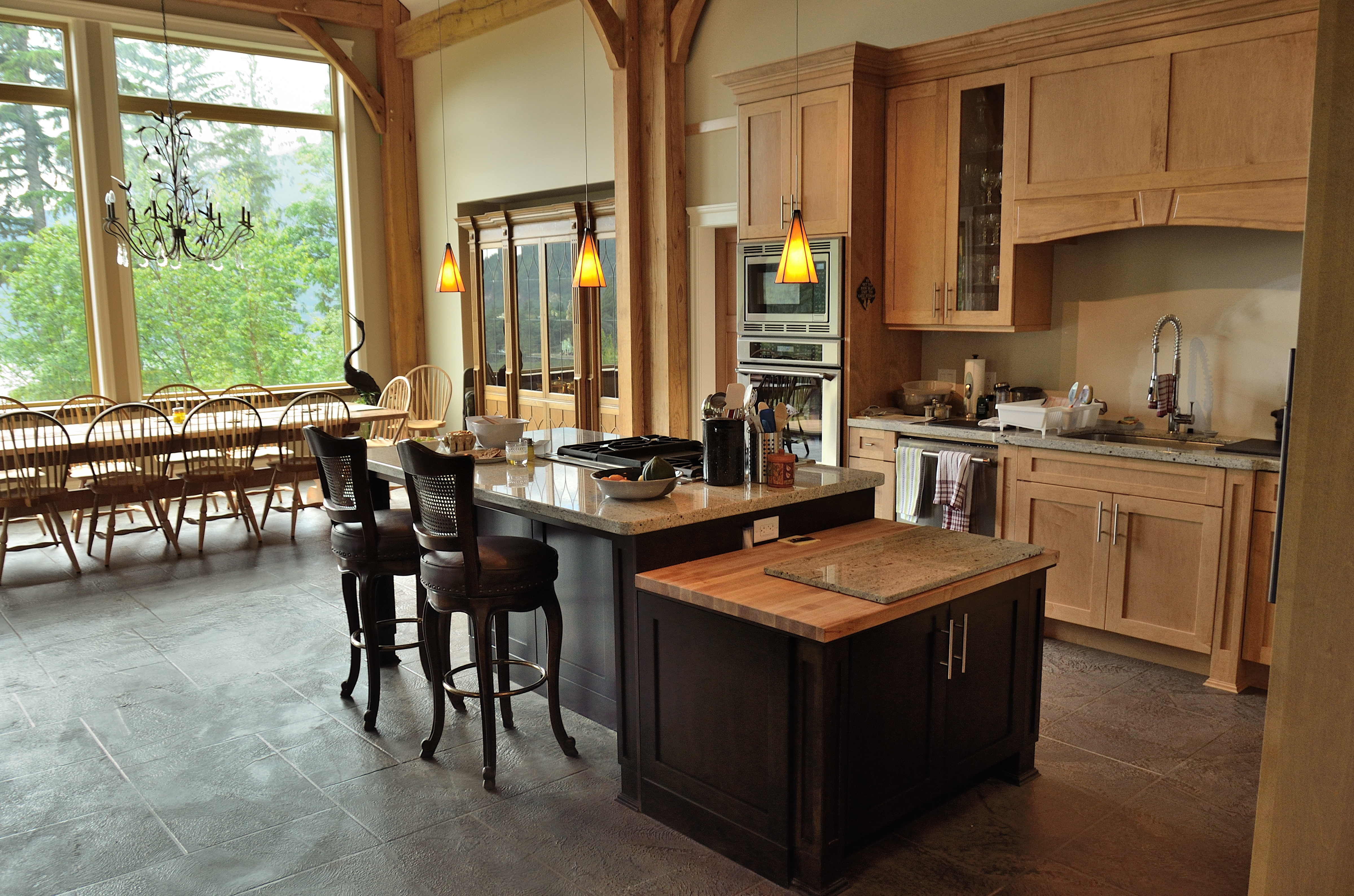Timber-frame kitchen with grey StoneCraft slate flooring and island