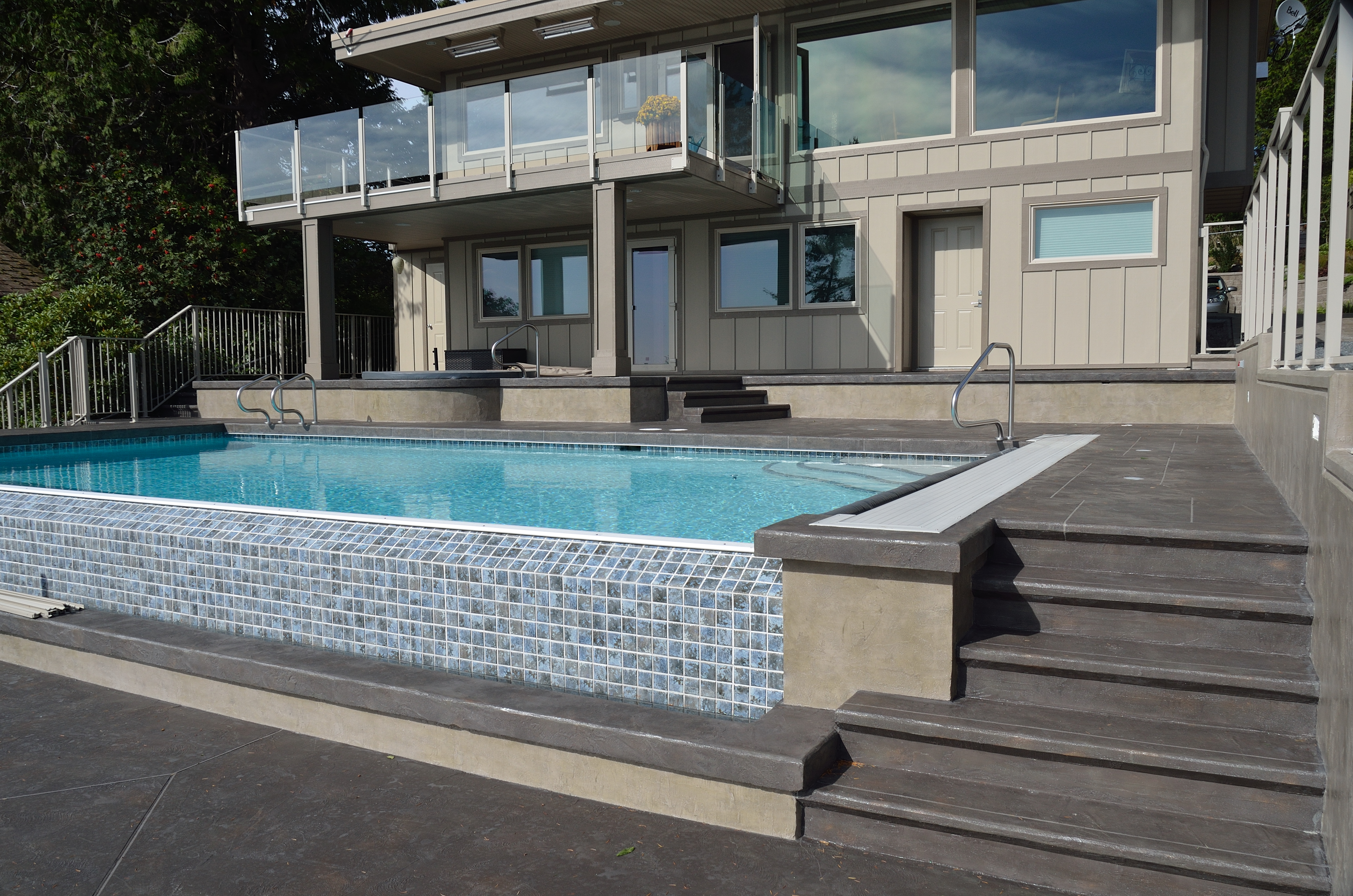 Residential pool area with StoneCraft slate deck surfacing and steps