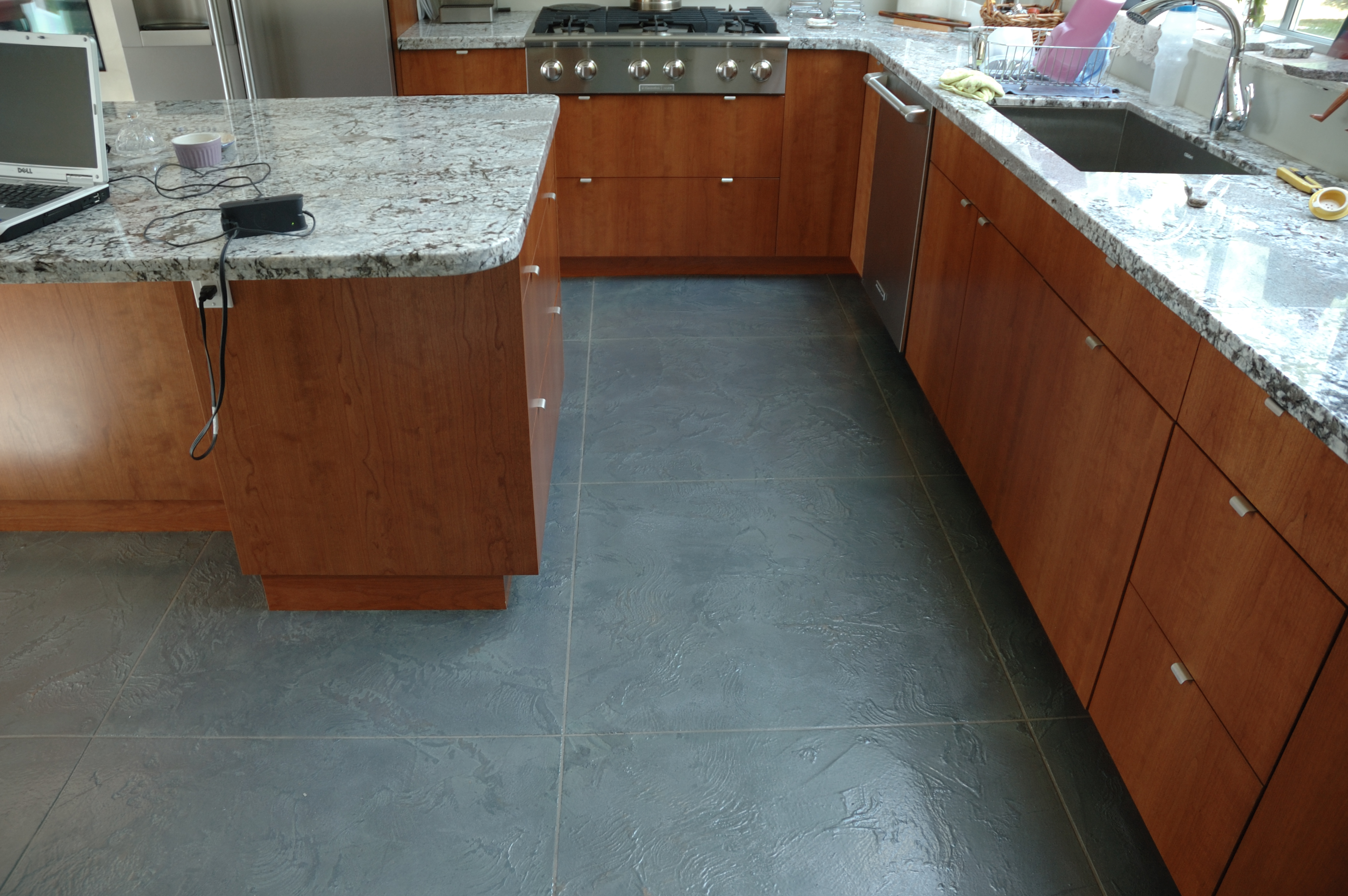 Modern kitchen with blue-grey StoneCraft slate flooring and cherry cabinets