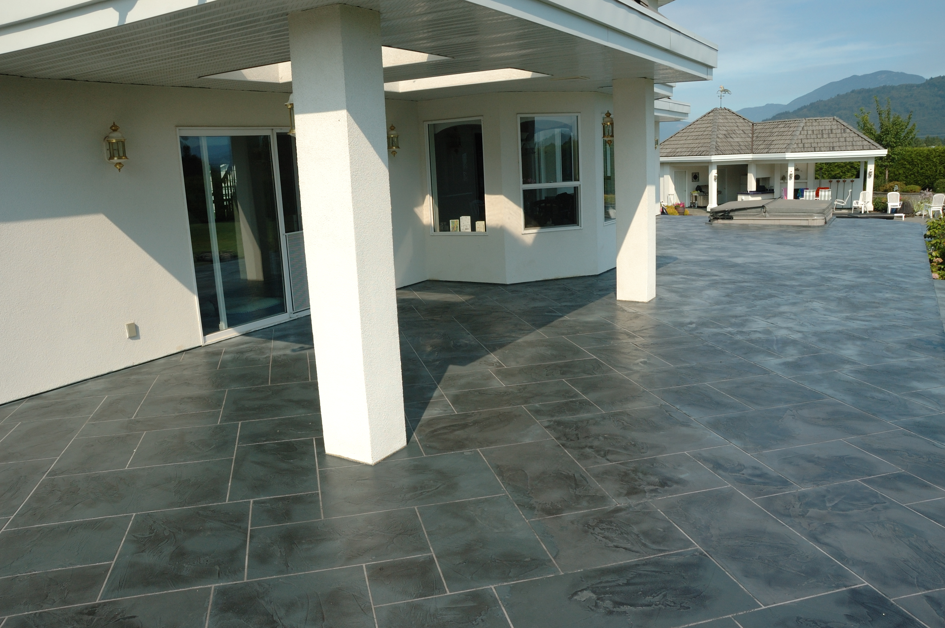 Large covered patio with charcoal StoneCraft slate surfacing